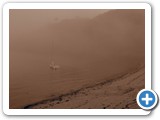 Isolated boat in misty, sepia Fermain Bay